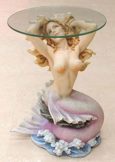 Glass topped mermaid table. Mermaid has blond hair and a pink tail, sitting on waves Wooden Mermaid Table, Wooden Mermaid Shelves, Pearl Mermaid Bed, Mermaid Picnic Table, Unique Bowls Mermaids, Mermaid Table, Mermaid Bar, Pastel Highlights, Mermaid Sculpture