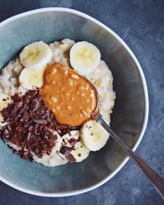 a bowl filled with oatmeal, chocolate and bananas