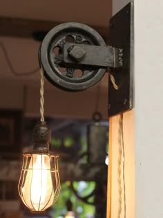 an old fashioned light hanging from the side of a building