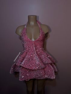 a mannequin wearing a pink dress with sequins