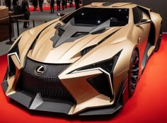 a gold colored sports car on display at an auto show