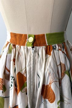 ALL VINTAGE IS FINAL SALE This skirt is just darling! Made from a vintage tablecloth in white, orange and olive green. The print looks like a picnic style print with hot dogs, hamburgers mushrooms, onions, salad, fruit, salt and pepper shakers and other cooking utensils. Zip up back with a button on the waistband. 100% cotton. approx. Medium WAIST: 28 IN with 1" extra Length 28 IN Excellent condition Picnic Print, California Sweater, Apron Ideas, Salad Fruit, Picnic Style, Vintage Witch, Vintage Tablecloths, Gathered Skirt, Salt And Pepper Shakers