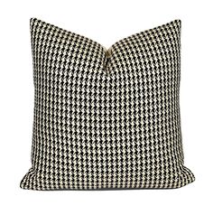 a black and white houndskin pillow on a white background with the words,'home is