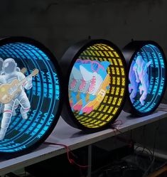 three neon signs with an astronaut playing guitar on one side and another in the other