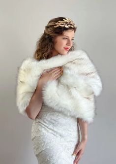 a woman wearing a white fur stole