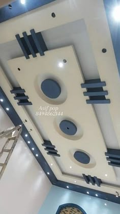 the ceiling is painted white and has blue circles on it, along with other decorations