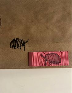 a zebra and an antelope are on the floor next to a piece of wax paper