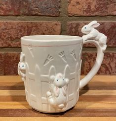 a white coffee mug with rabbits on it