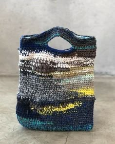 a multicolored bag sitting on top of a cement floor