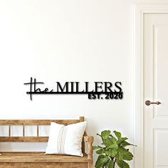 a wooden bench sitting in front of a white wall with the word'the millers'on it