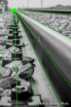 black and white photograph of rocks on train tracks