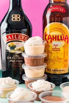 cupcakes and bottles of kahlua on a table with frosting in them