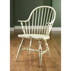 a white chair sitting on top of a hard wood floor