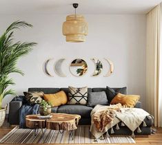 a living room filled with lots of furniture and decor on top of a hard wood floor