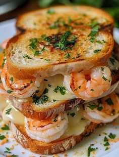 a grilled sandwich with shrimp and cheese on it sitting on a plate next to some parsley