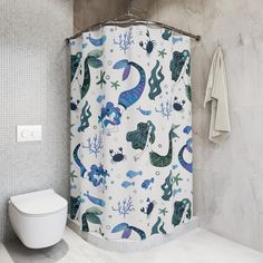 a white toilet sitting next to a shower curtain