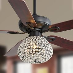 a ceiling fan with a crystal ball light hanging from it's blades and wooden blades