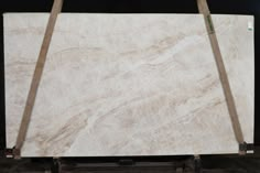 white marble is stacked on top of each other in front of a black background,