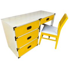 a yellow and white desk with two chairs