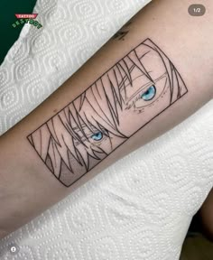 a woman's arm with an anime character and blue eyes on the left forearm