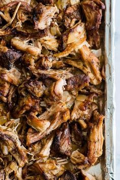 crispy slow cooker carnitas in a baking tin with text overlay