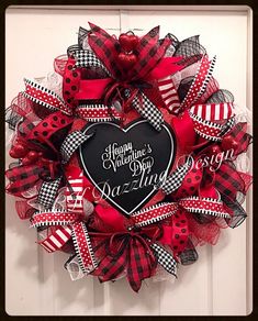 a valentine's day deco mesh wreath with a black heart and red ribbon on the front door