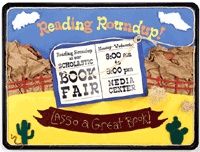 a sign that says reading roundup and has an image of a book fair on it