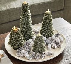 three small christmas trees on a white plate