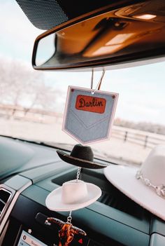 a car dashboard with a hat hanging from the dash board