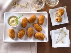 some food is sitting on a white plate and next to two glasses with water in them