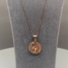 Celebrate the elegance of history with this 925k silver chain adorned with a rose gold-covered charm inspired by Roman Imperial coins. The delicate rose gold finish enhances the intricate details of the coin, blending ancient artistry with modern sophistication. Perfect for those who appreciate unique, meaningful jewelry, this necklace is versatile enough for both everyday wear and special occasions. A timeless piece that adds a touch of historical charm to any outfit. 1. Avoid Moisture: Remove Roman Coin Necklace, Perfumes And Lotions, Sixth Form Outfits, Sixth Form, Gold Coin Necklace, Charm Necklace Silver, Forever Jewelry, Meaningful Jewelry, Gold Coin