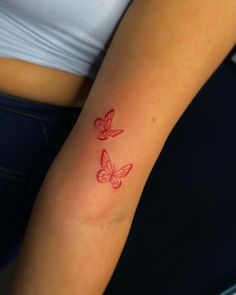 two red butterflies on the left arm