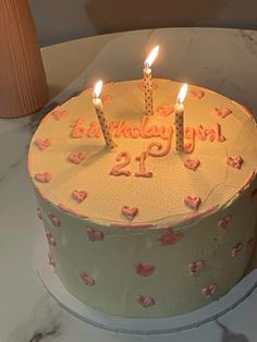 a birthday cake with three candles on it