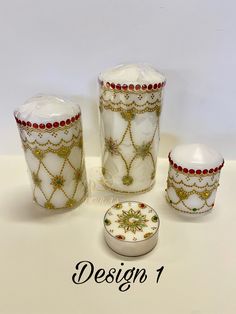 a set of three white glass vases sitting next to each other on top of a table