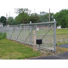 a fenced in area next to a grassy field