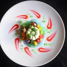 a white plate topped with lots of colorful food