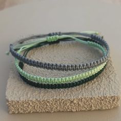 Handmade  string macrame surfer bracelet. Water resistant summer bracelet. Great gift for her & him. Woven beach bracelet. Dark Green string, Green string and grey string options.  Size is suitable between 5.90 inches and 11.80 inches ( 15 cm to 30 cm ) For the perfect fit send us your size by measuring your wrist with a tape or string. We make also custom bracelets for kid size. Comes in branded gift box. Cheap Green Casual Friendship Bracelets, Green Adjustable Cord Friendship Bracelets For Beach, Green Waxed Cord Friendship Bracelets For Beach, Handmade Green Braided Bracelet For Beach, Surf Jewelry Bracelet, Casual Green Hand-wrapped Friendship Bracelet, Green Resizable Braided Bracelets For Beach, Surf Bracelets, Bracelet String