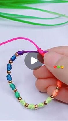 someone is making a beaded bracelet with beads