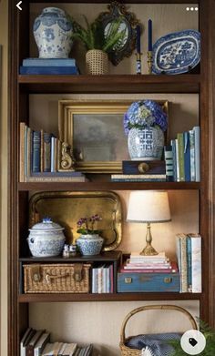 a book shelf filled with books and vases