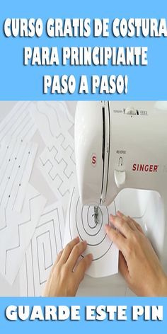 a woman is using a sewing machine to sew on the paper with her hands