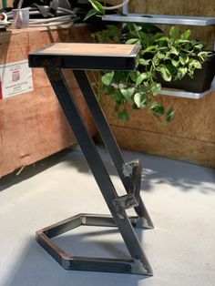 a small table that is sitting on the floor in front of some potted plants