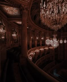 an ornate chandelier hangs from the ceiling in a large room with many chandeliers