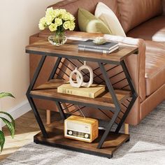 a living room with a couch, table and bookshelf next to a window