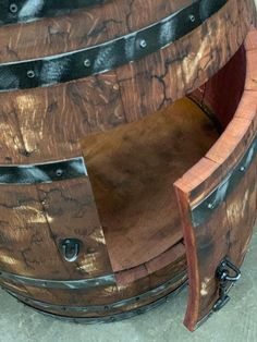 a wooden barrel sitting on top of a cement floor