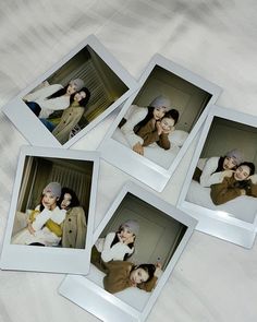 four polaroid photos of two women and one man are laying on a bed with white sheets