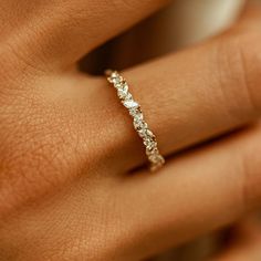 a woman's hand with a diamond ring on it