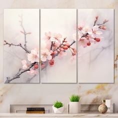 three paintings on a wall with flowers in the middle and one is pink, while the other two are white