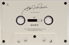 an old, white cassette player with autographs on it