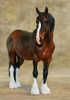 a brown and white horse standing on top of a floor