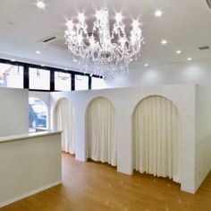 an empty room with white walls and chandelier